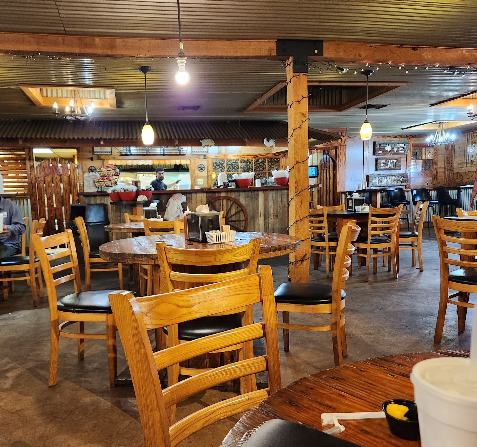 Rustic dining room with wooden tables and string lights
