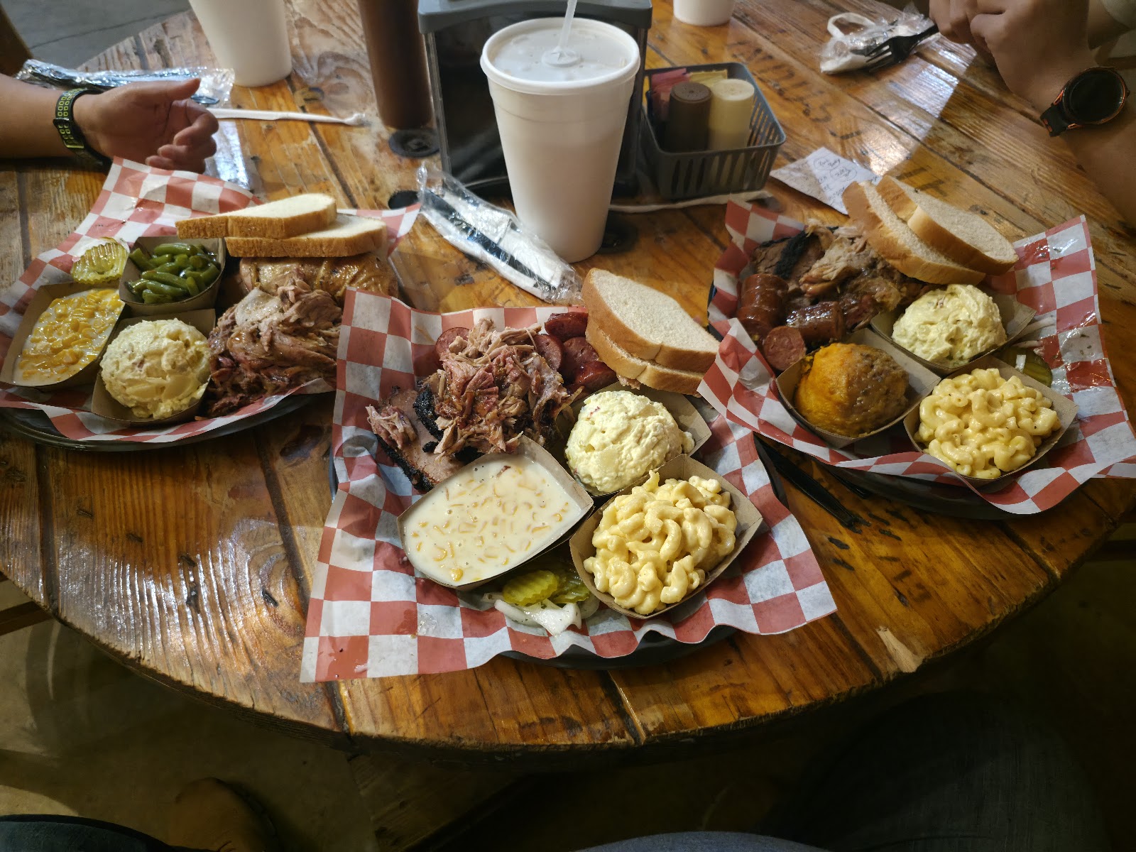 Smoked chicken quarter, brisket and sausage plate with corn and potato salad