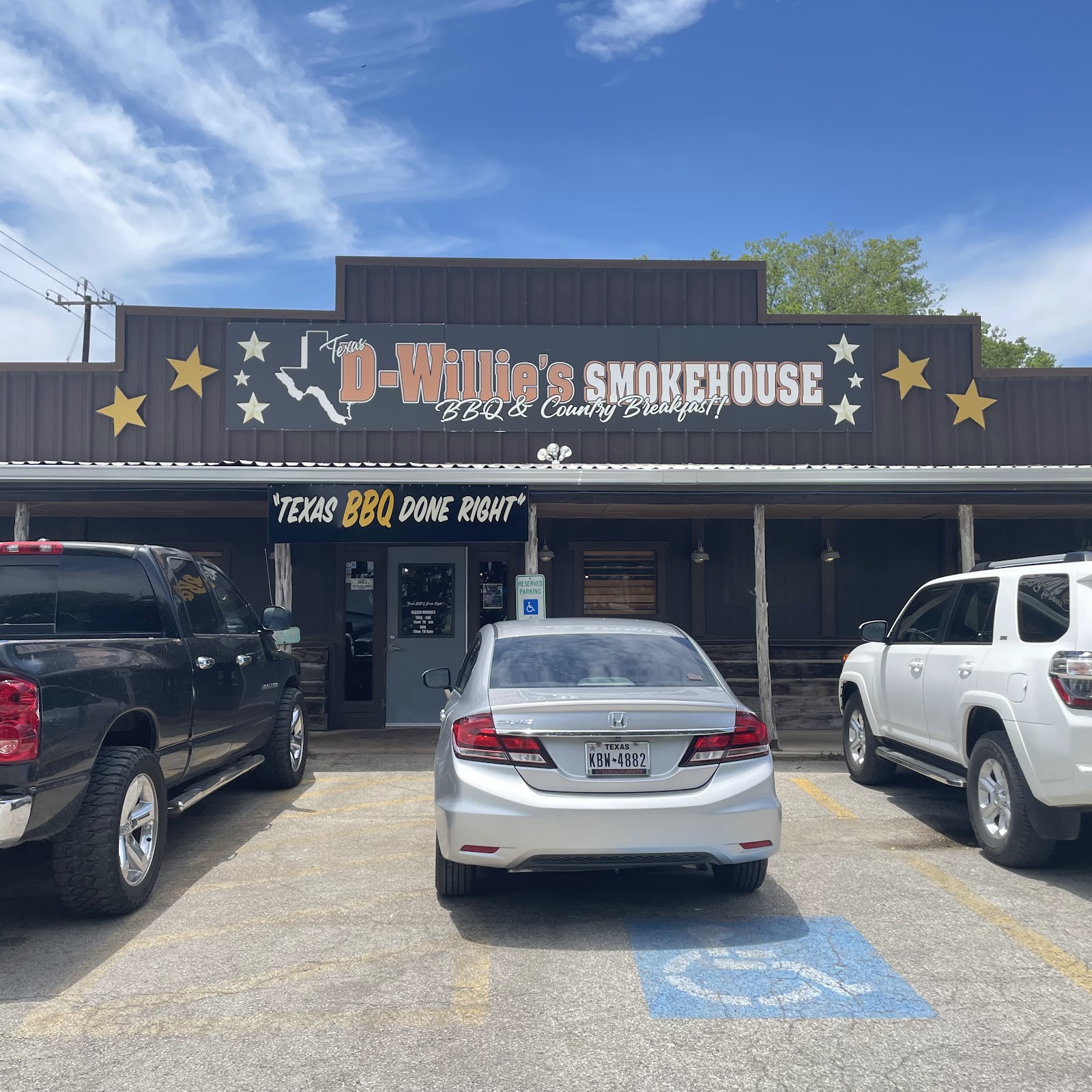 Texas D Willie's Smokehouse storefront sign reading Texas BBQ Done Right