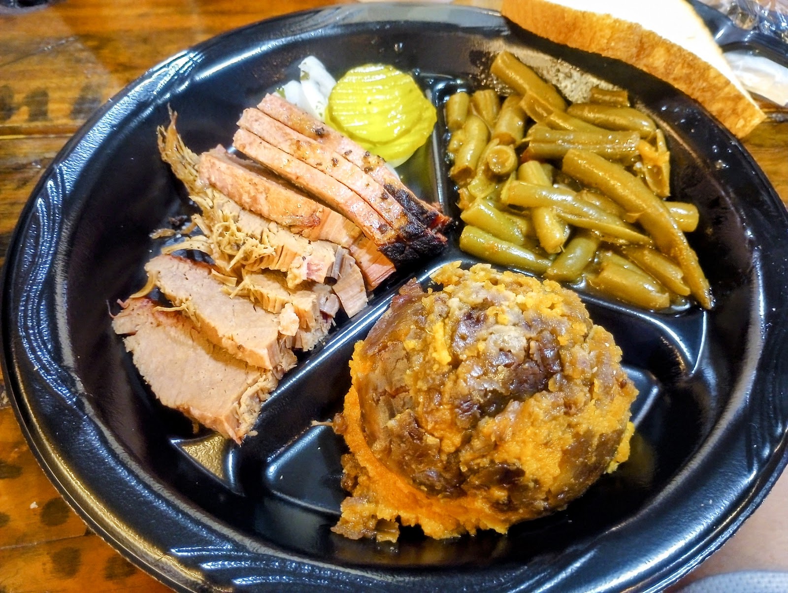 Guests dining inside the wood-paneled Texas D Willie's Smokehouse dining room